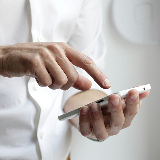 Person with phone Photo by NordWood Themes on Unsplash